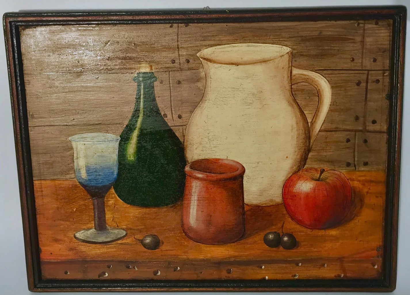 Still life of a glass, pitcher, bottle, apple and capulis on table