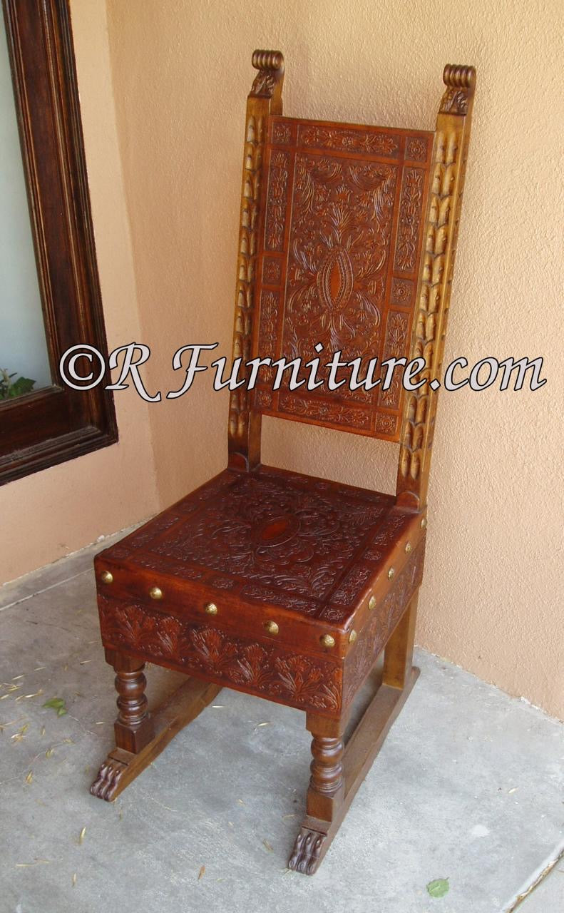 A hand-carved leather side chair with intricate Renaissance-style designs, featuring a wooden frame and a hand tooled leather seat.